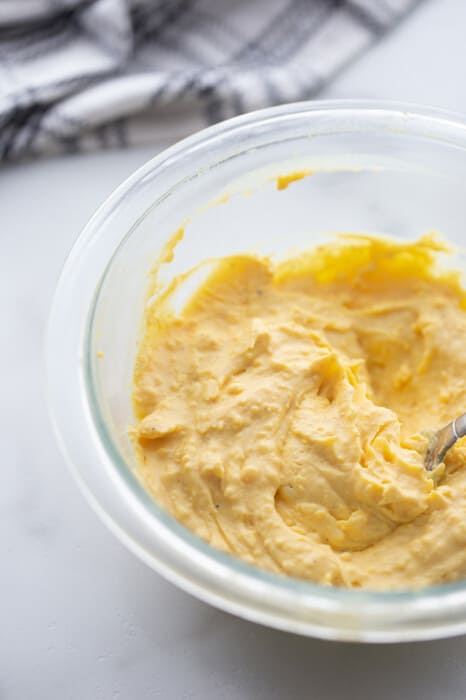 Mash the yolks until crumbly, then add mayonnaise, mustard, vinegar, salt, pepper, and paprika. Stir until the mixture becomes smooth and creamy