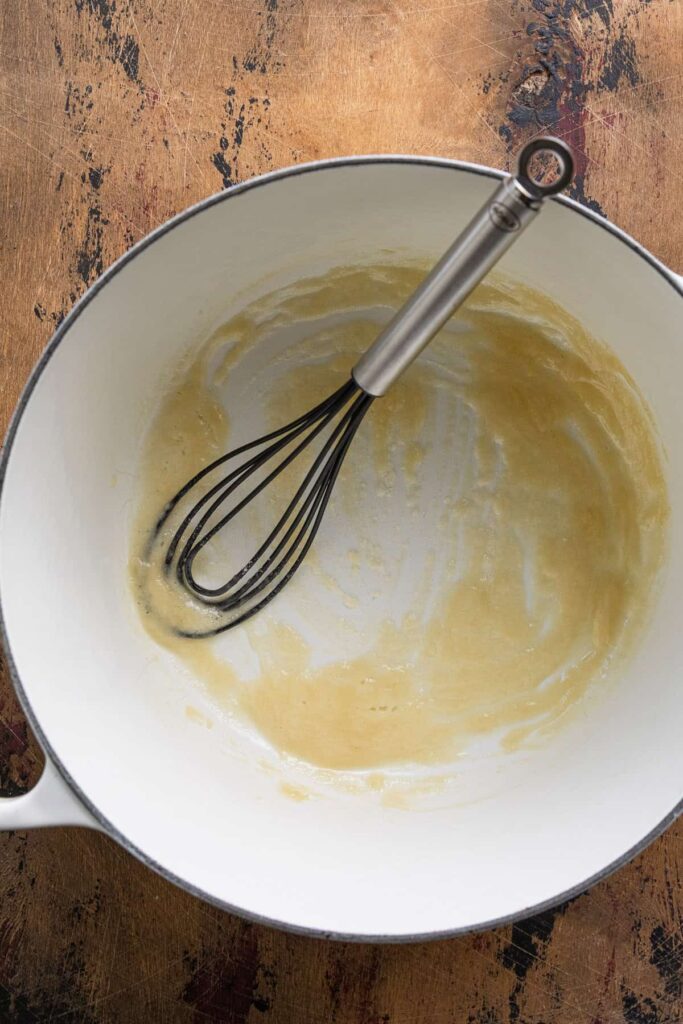 Melt butter in a saucepan over medium heat, then stir in flour and cook until it develops a light golden color and a slightly nutty aroma