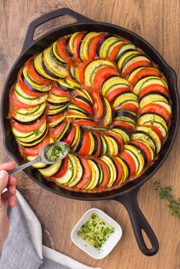 Mix the olive oil, garlic, and thyme together and drizzle evenly over the arranged vegetables