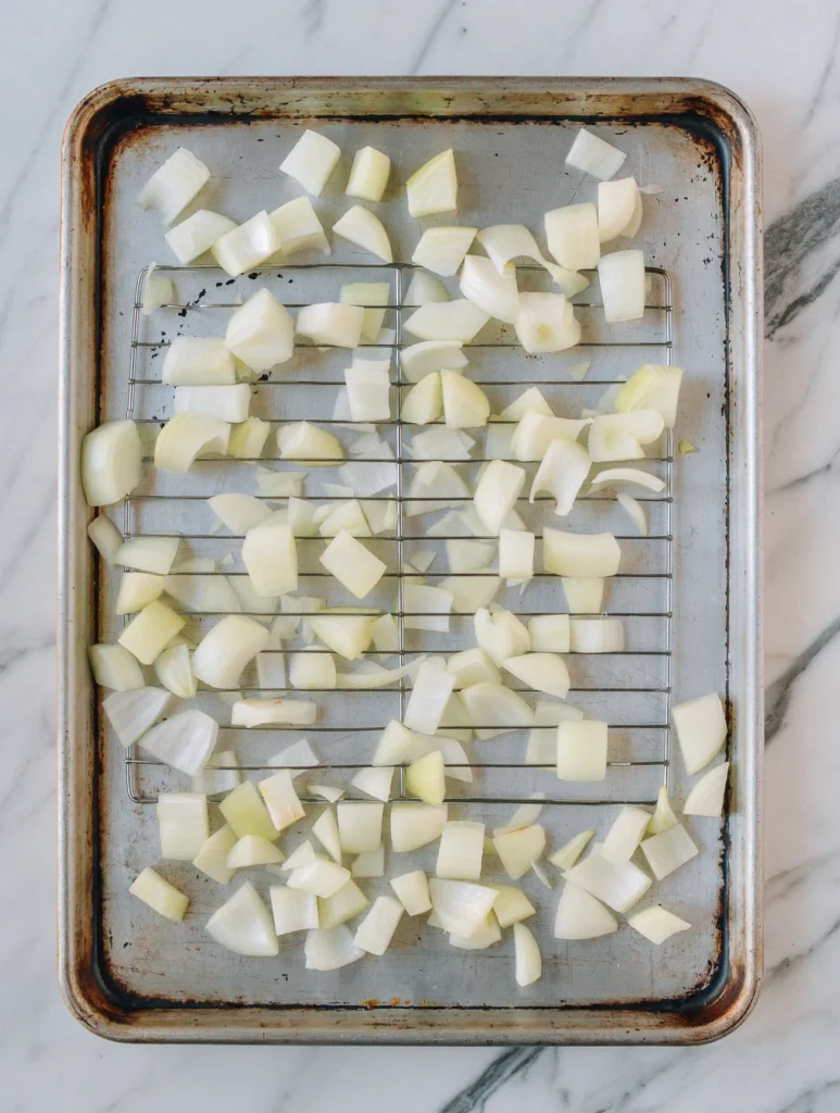 Place sliced onions across the bottom of a roasting pan or on a rack, then set the roast on top