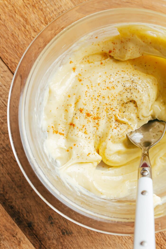 Place the egg yolk and Dijon mustard in a bowl and whisk until smooth and slightly thickened