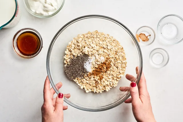 Place the rolled oats, milk, yogurt, sweetener, chia seeds if using, cinnamon, and salt into a large bowl