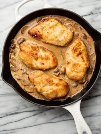 Pour in the cream and return the chicken to the pan, cooking until the chicken is fully done and the sauce thickens
