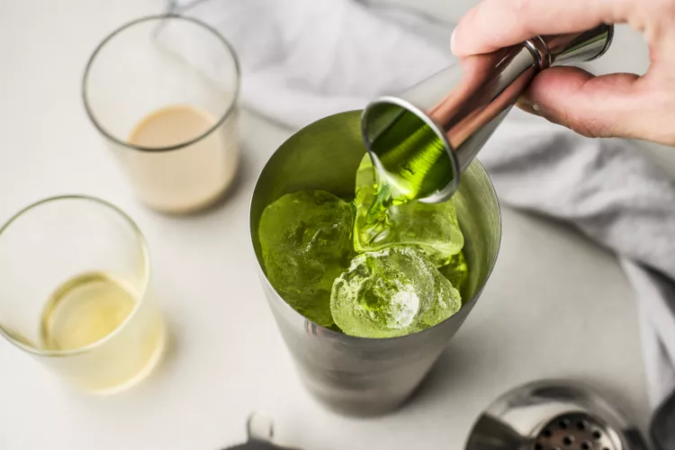 Pour the Irish whiskey, melon liqueur, and Irish cream liqueur into the shaker