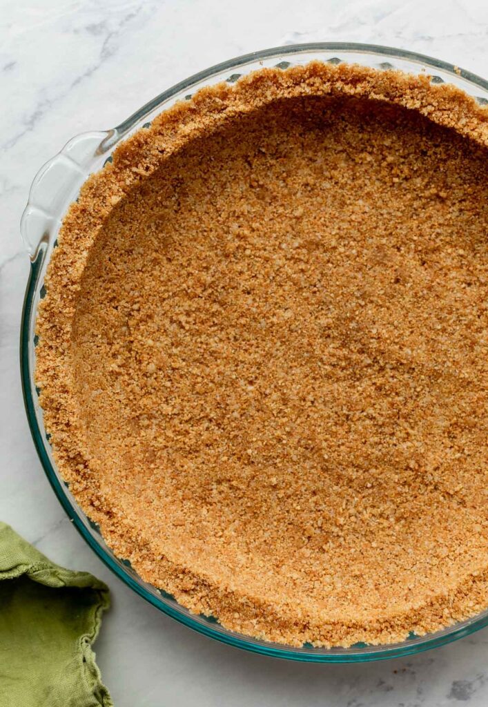 Press the mixture into the bottom and up the sides of an ungreased pie dish, using gentle, even pressure so the crust holds together without becoming too compact