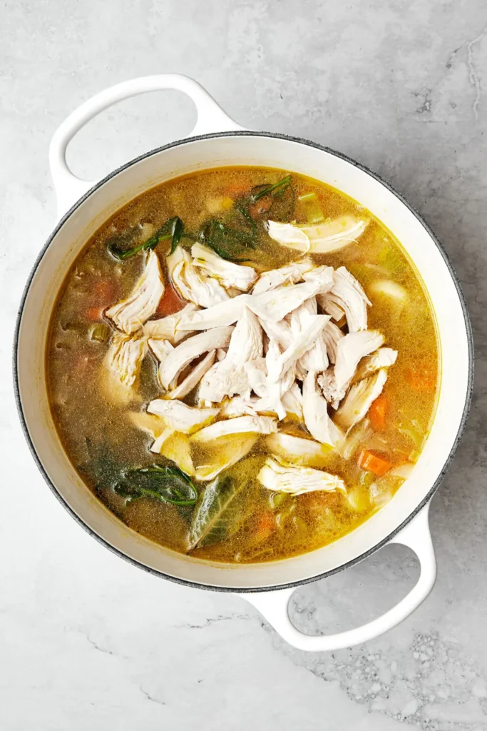 Return the shredded chicken to the soup and allow it to simmer briefly so the flavors blend together