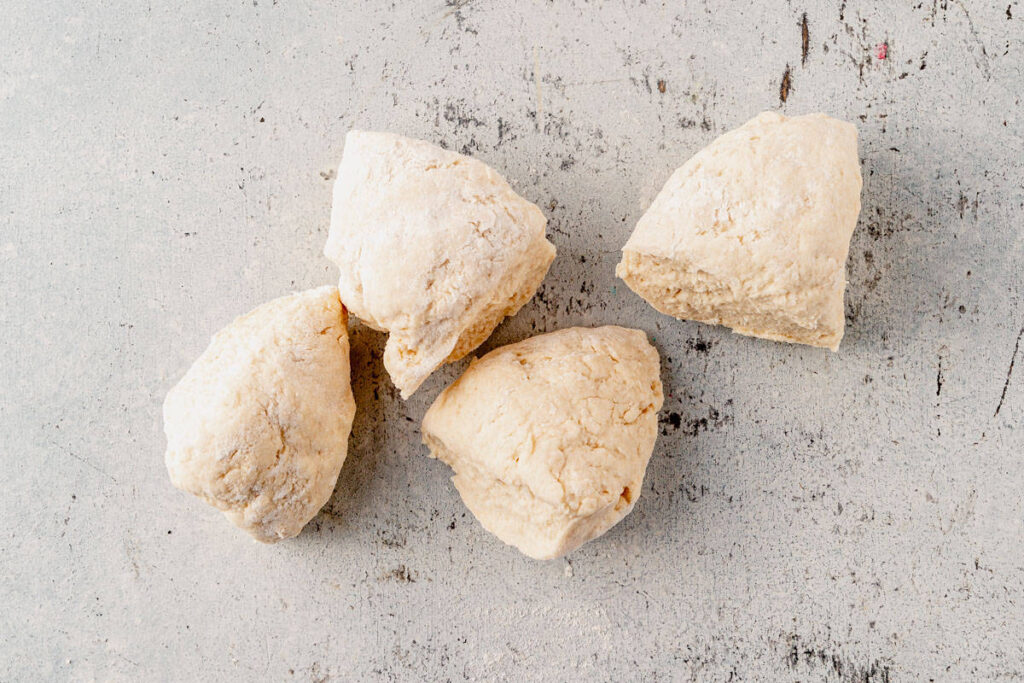 Roll the dough into a ball and divide into 4 equal portions (about 80g each if weighing)