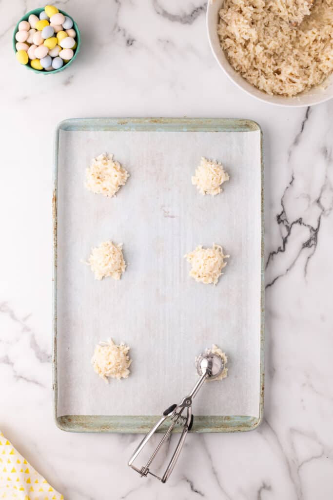 Scoop mounds of the mixture onto the prepared baking sheet, spacing them slightly apart