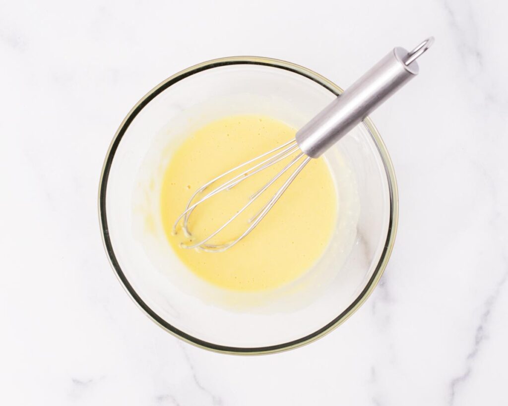 Sift in the flour and baking powder, then mix until the batter becomes smooth with no dry spots