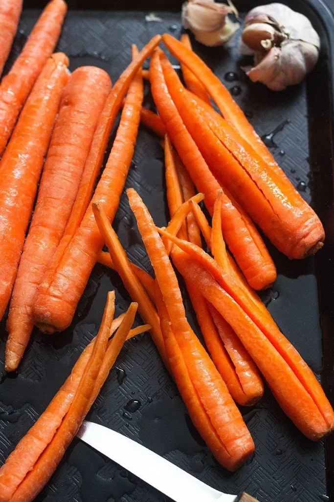 Slice the carrots lengthwise into quarters, keeping the base intact if desired for presentation and even cooking