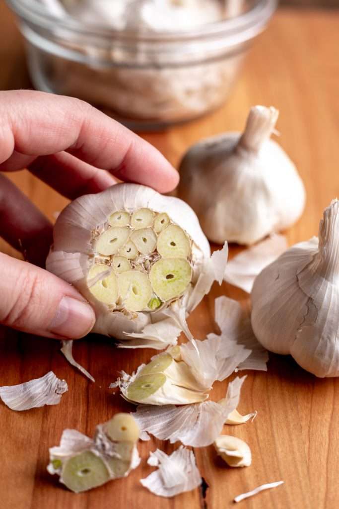 Slice the tops off the garlic heads, keeping the skins on so the cloves stay intact