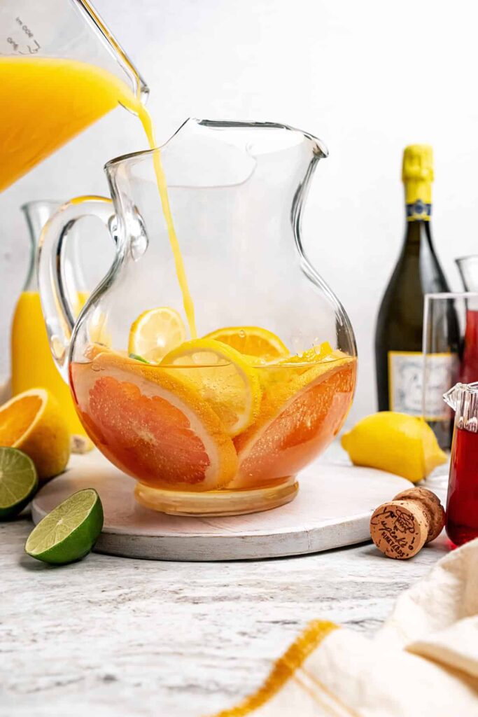 Slowly add the orange juice into the pitcher, letting it naturally combine with the sparkling wine
