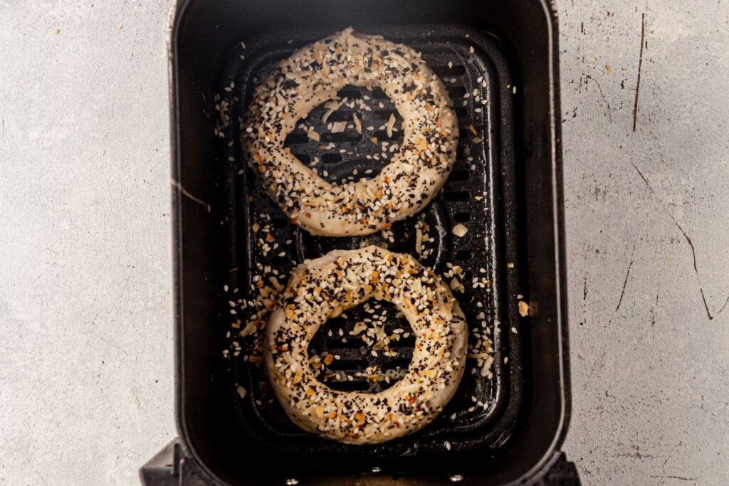 Spray basket lightly with nonstick spray. Air fry bagels for 12–14 minutes until golden and cooked through