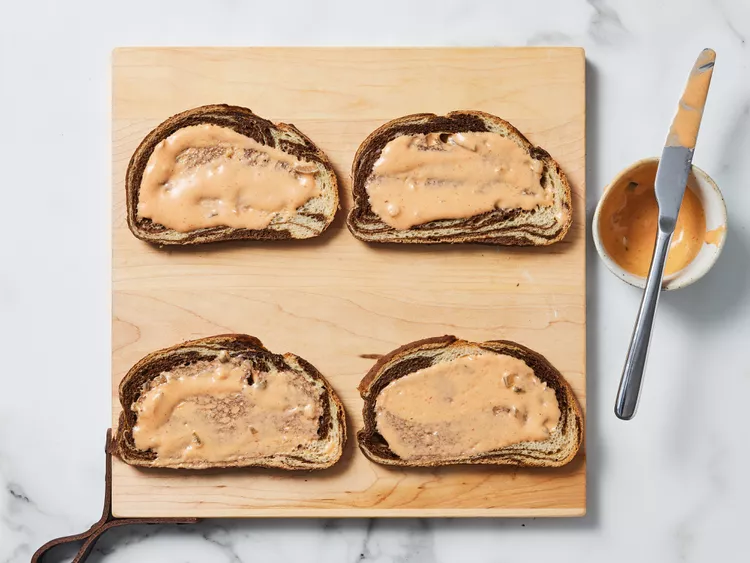 Spread Thousand Island dressing evenly on one side of each slice of rye bread