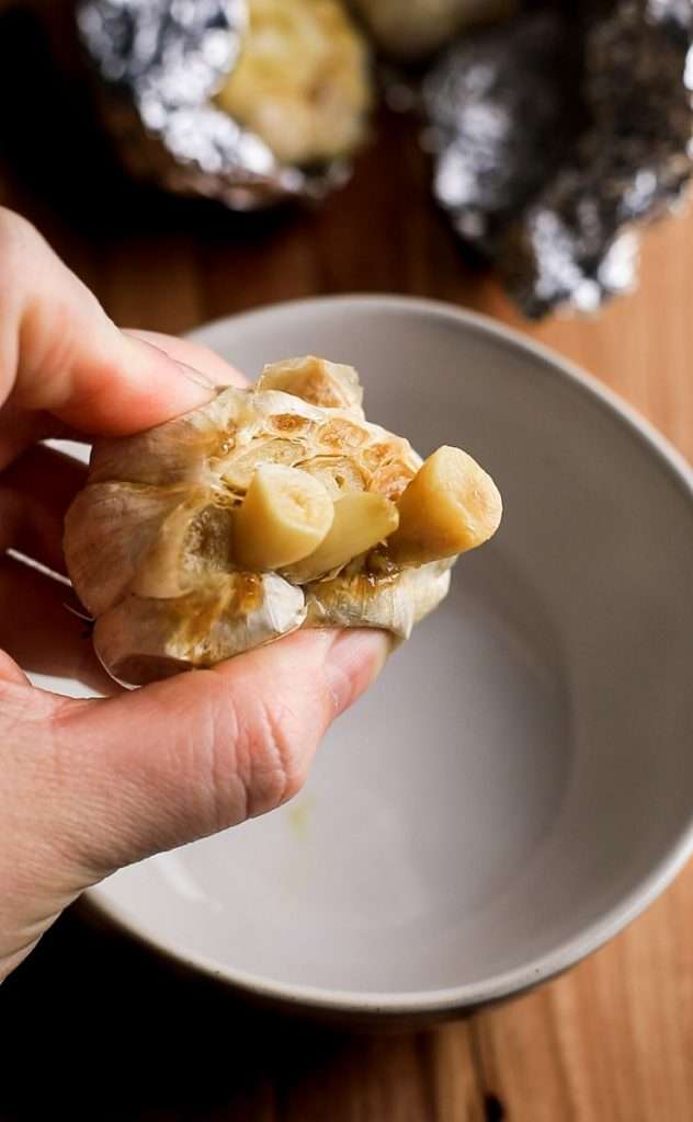 Squeeze the roasted cloves out of their skins into a small bowl and mash into a smooth paste