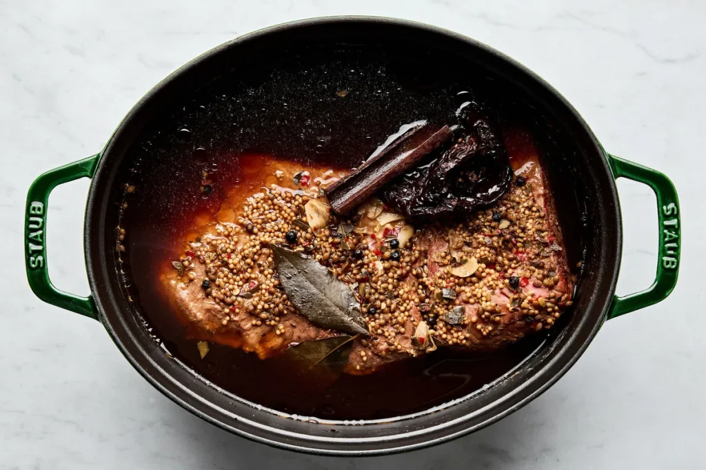 Bring the mixture to a simmer over medium-high heat, then reduce the heat to low. Cover and cook gently until the beef becomes tender, about 4 to 5½ hours.