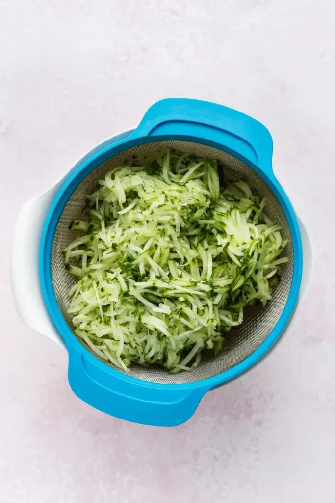 Transfer the grated cucumber into a fine mesh sieve set over a bowl
