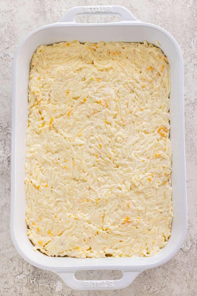Transfer the mixture into a lightly greased baking dish and spread it out into an even layer