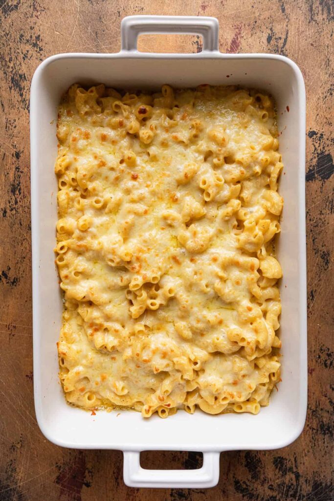 Transfer the mixture to the prepared baking dish and top with shredded cheddar cheese