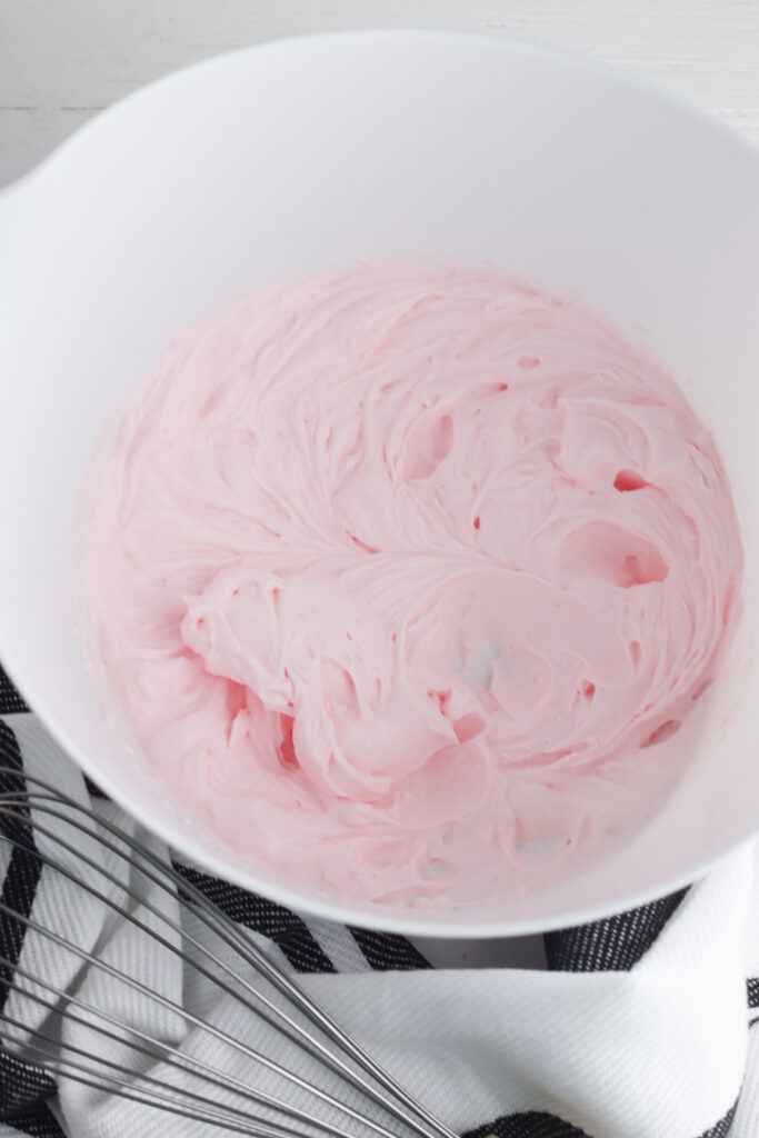 Whip on high speed until the mixture thickens and stiff peaks begin to form. This creates the pink lemonade whipped topping