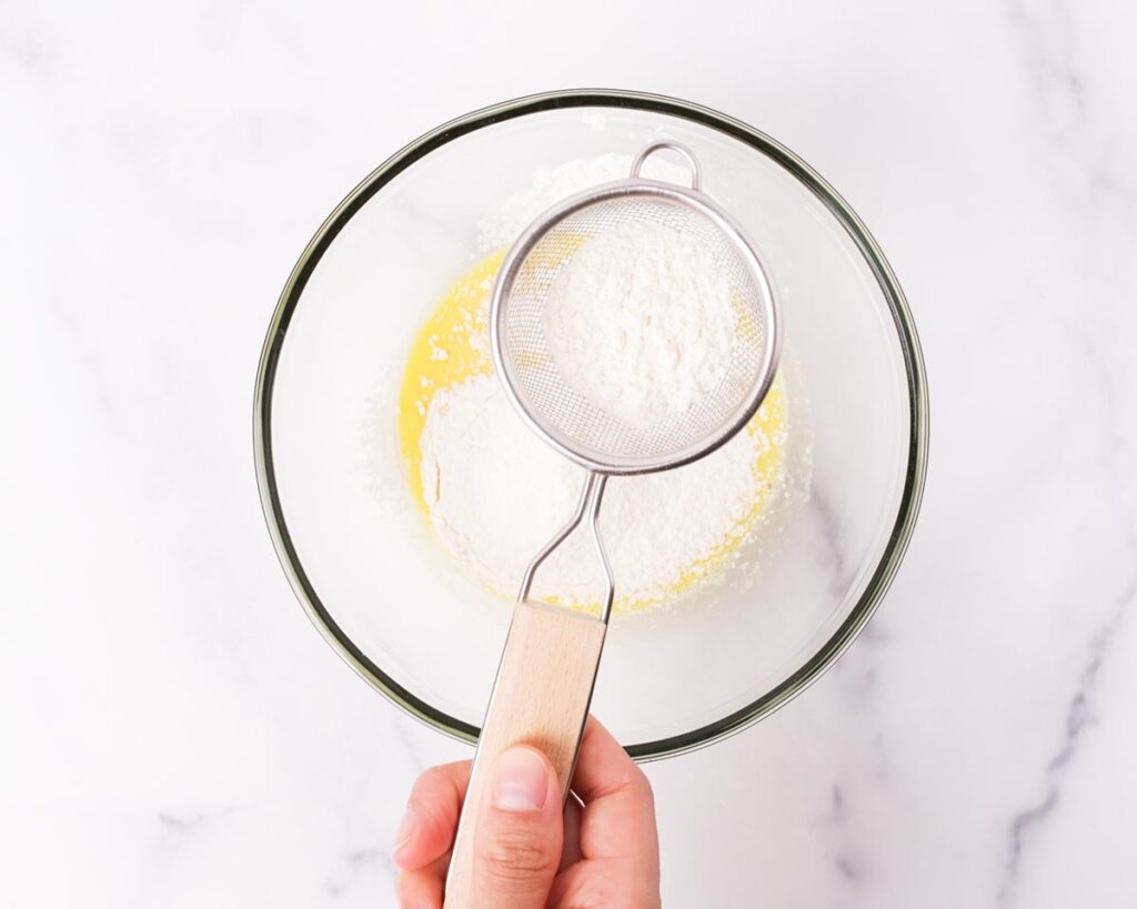 Whisk the egg yolks with milk, vanilla, and lemon zest until combined