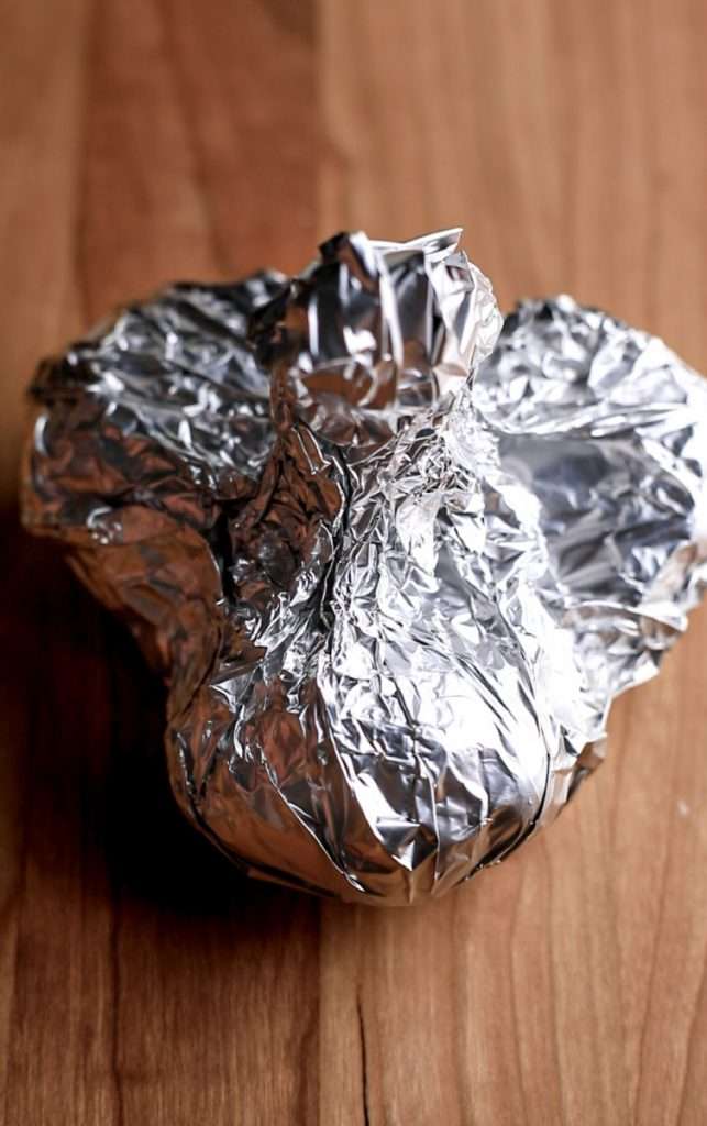 Wrap the foil tightly around the garlic to seal it