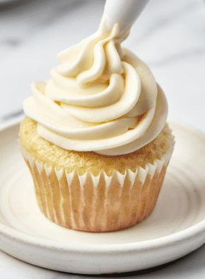 Once the cupcakes are fully cooled, frost them generously using a piping bag or spatula