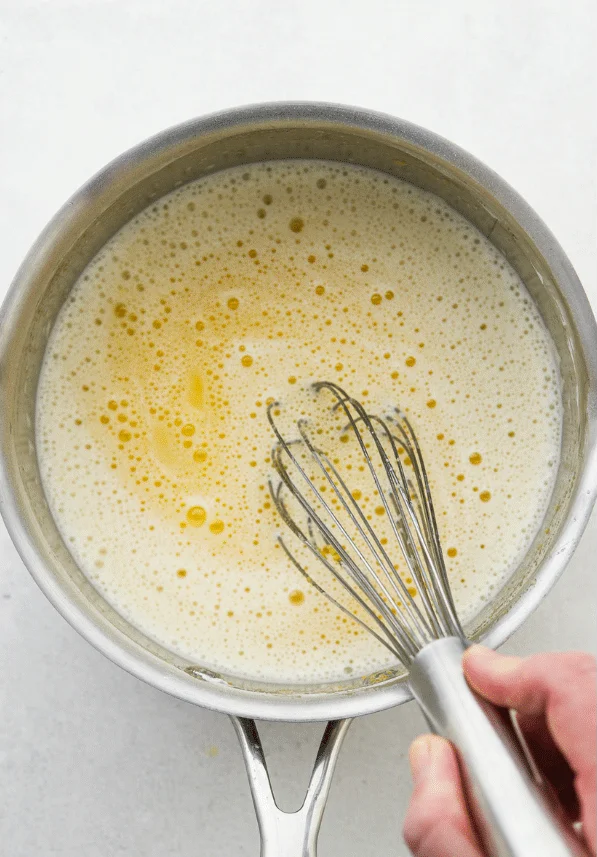 then whisk in water and egg yolks until smooth