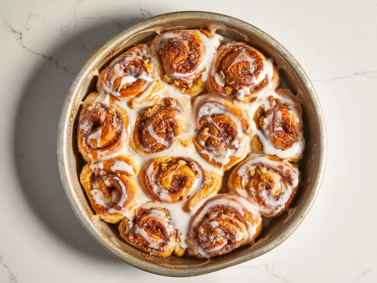 Transfer the pans to a preheated oven at 350°F (175°C) and bake until the rolls turn golden brown and cooked through. While the rolls are still warm, mix together the confectioners’ sugar, milk, and vanilla extract until smooth, then drizzle over the top before serving.