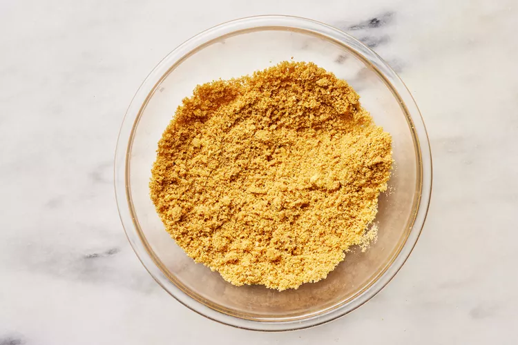 In a mixing bowl, combine the graham cracker crumbs, sugar, melted butter, and cinnamon if using, and mix until the texture resembles damp sand and everything is evenly coated.