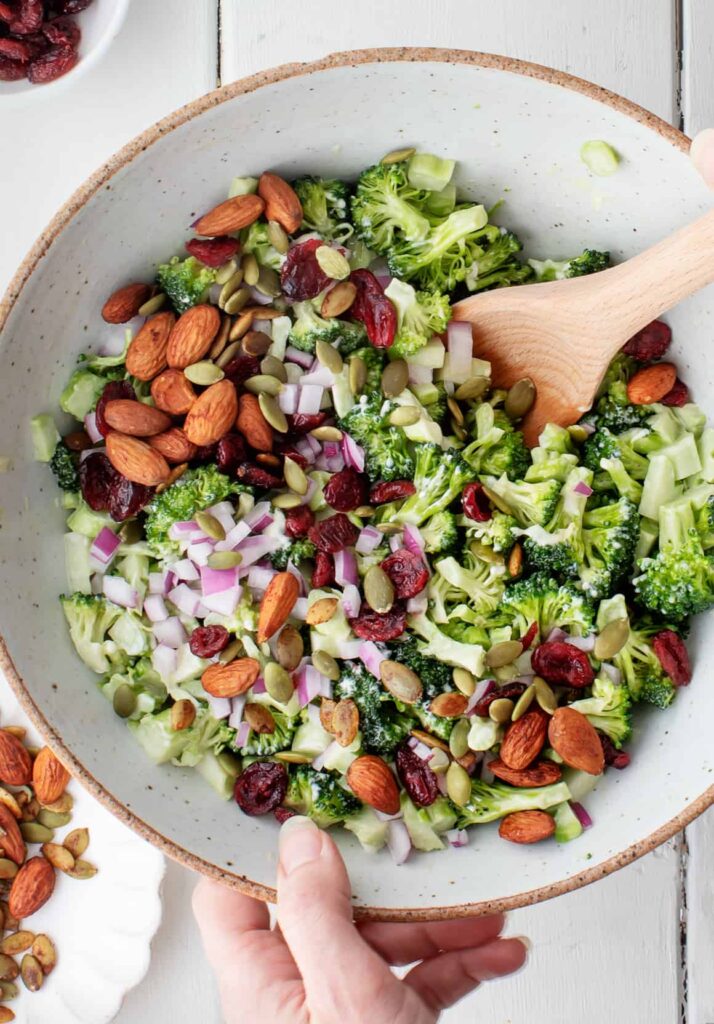 Add most of the roasted nuts and seeds to the salad and toss gently, reserving a small portion for garnish