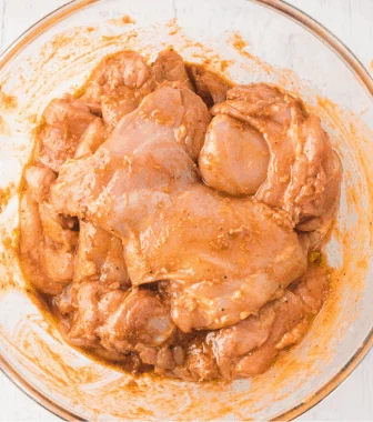 Add the chicken thighs and coat them thoroughly in the marinade