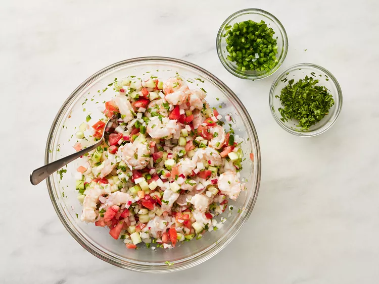Add the chopped onions, tomato, cucumber, radishes, and minced garlic to the shrimp