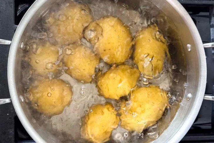 Add the potatoes to a large pot of cold water and bring to a boil