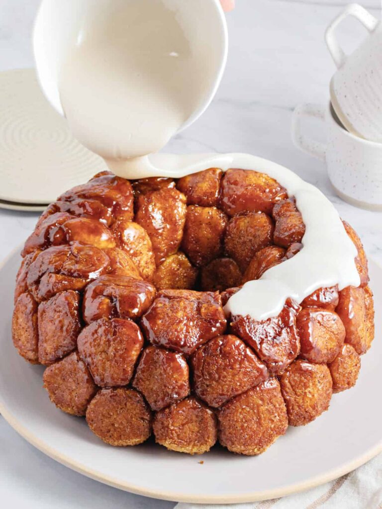 Prepare the glaze by mixing powdered sugar, milk, and vanilla until smooth, then drizzle over the bread before serving.