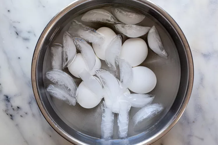 Carefully drain the hot water and immediately run cold water over the eggs or transfer them to a bowl of ice water to stop the cooking process