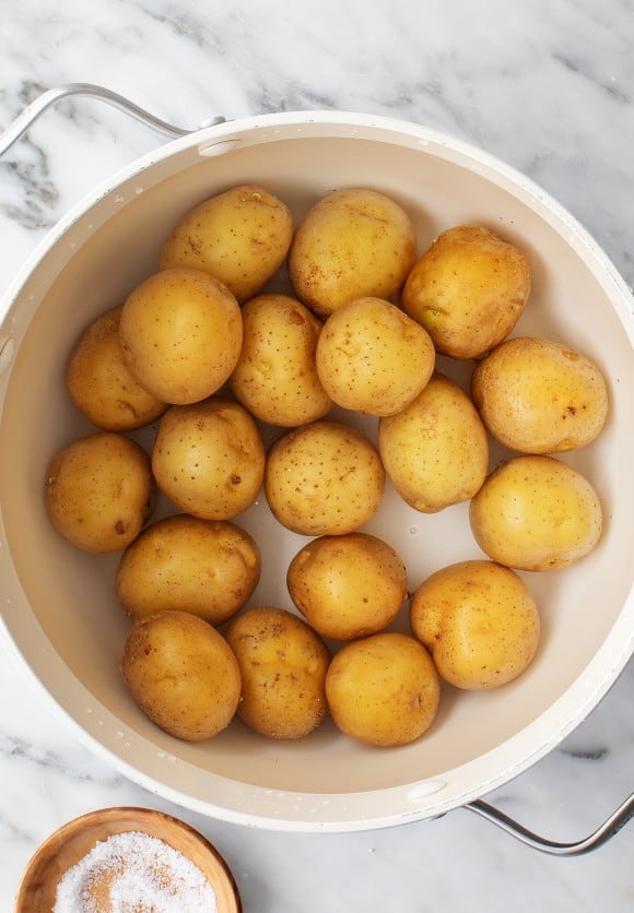 Drain the potatoes and let them cool slightly so they are easier to handle without breaking when smashed