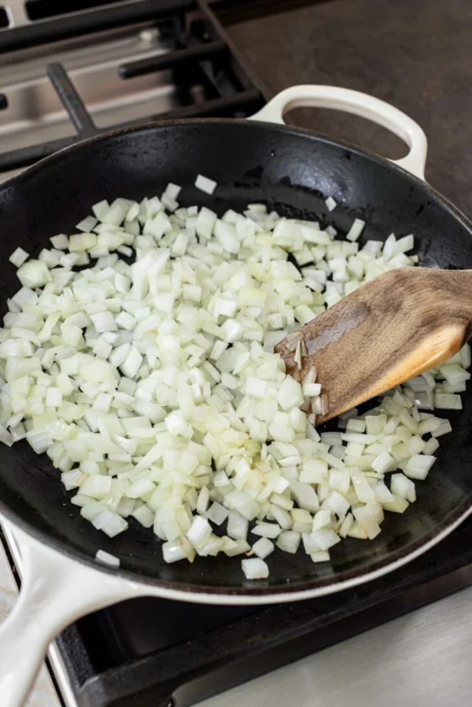 Heat olive oil in a skillet and cook the diced onion with a portion of salt until it softens and becomes slightly translucent