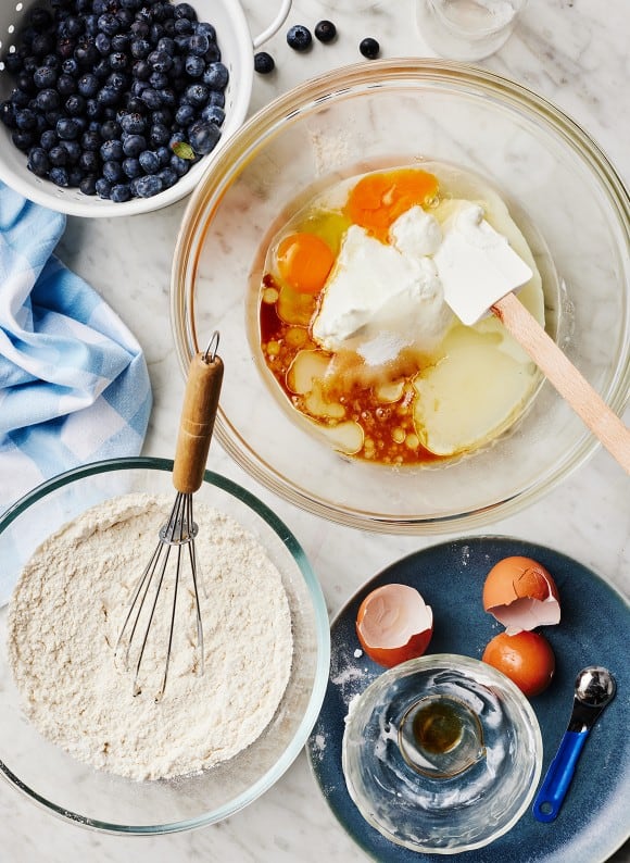 In a large bowl, whisk the yogurt, sugar, eggs, vegetable oil, milk, and vanilla extract until smooth and well combined