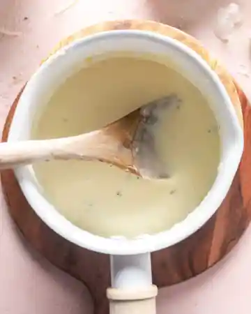 Let it simmer gently until it coats the back of a spoon, then remove from heat and stir in part of the cheeses until melted and smooth.