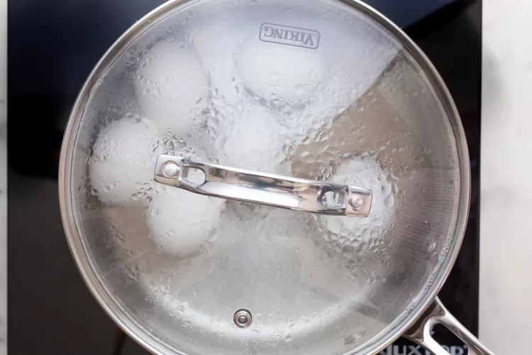 Once the water reaches a boil, turn off the heat, cover the pan with a lid, and allow the eggs to sit in the hot water until they reach your desired doneness