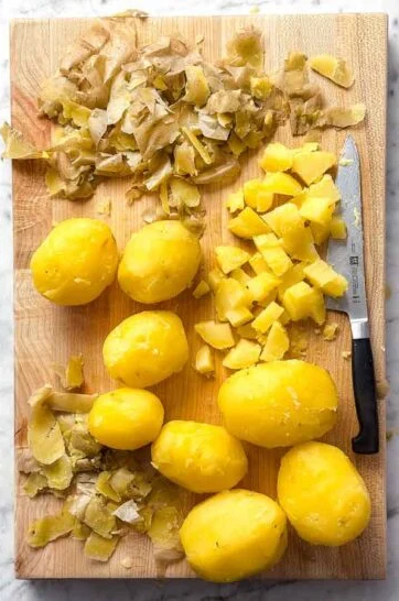 Peel the skins from the potatoes and cut them into evenly sized chunks