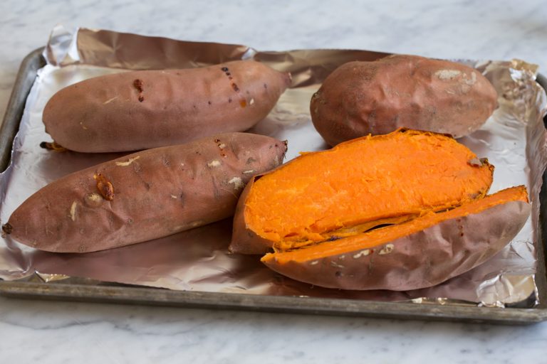 Pierce the sweet potatoes and place them on the sheet, then bake until they are soft and fully cooked