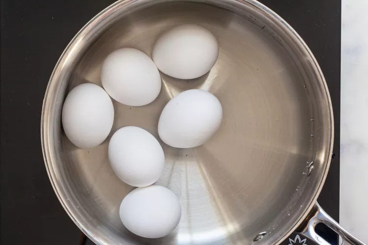 Place the eggs in a saucepan in a single layer and add enough cold water to cover them by at least an inch or two