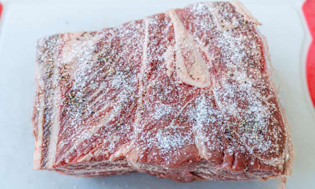 Preheat the oven and position the rack in the lower third. Season the roast generously with salt and pepper, then let it rest at room temperature to ensure even cooking.