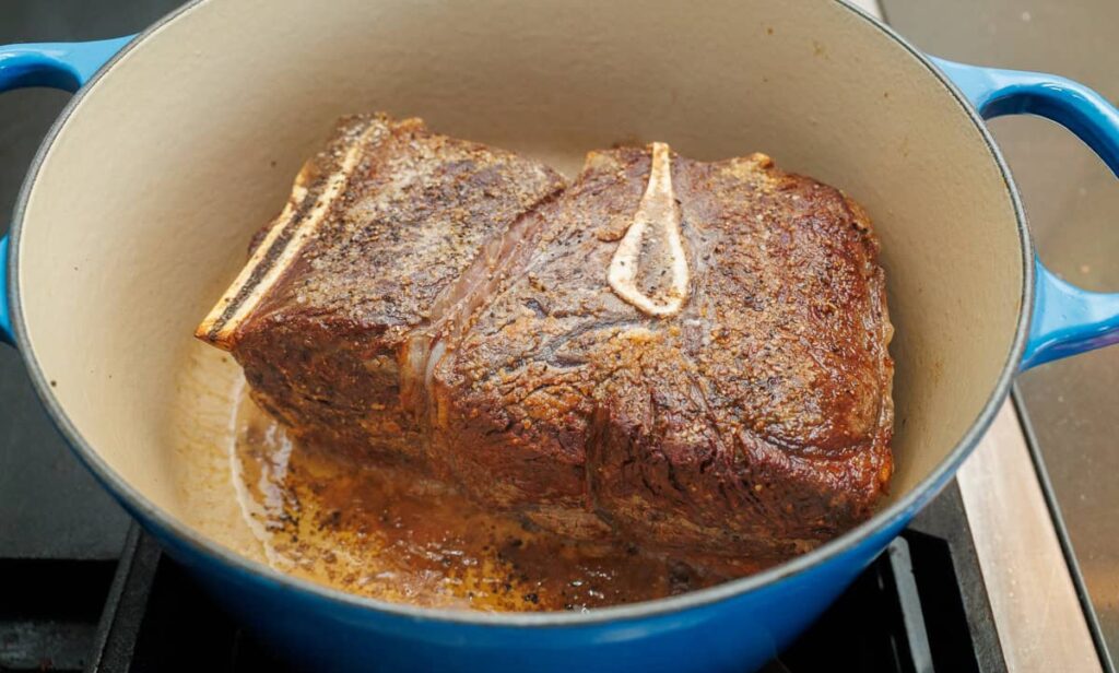 Heat oil in a large Dutch oven over medium-high heat. Once hot, sear the roast on all sides until a deep golden crust forms, then transfer it to a plate.
