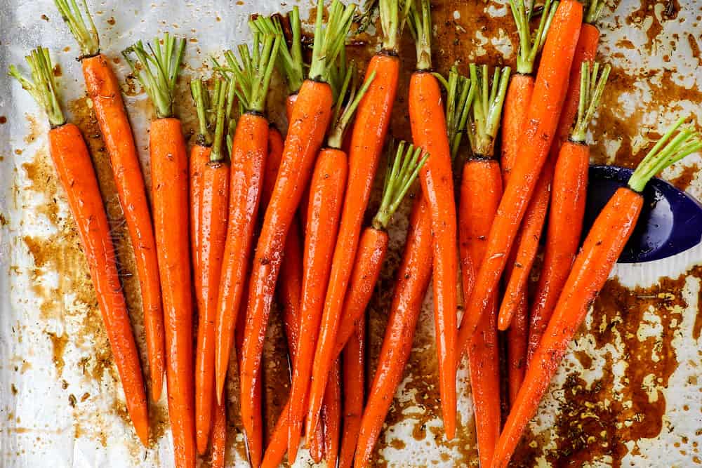 Remove the carrots from the oven and pour the prepared glaze over them. Toss thoroughly to coat, then spread them back into an even layer
