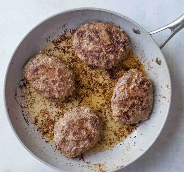 Heat oil in a skillet over medium heat. Add the patties and cook until both sides are golden brown and fully cooked through. Remove from the skillet and keep them covered to stay warm.