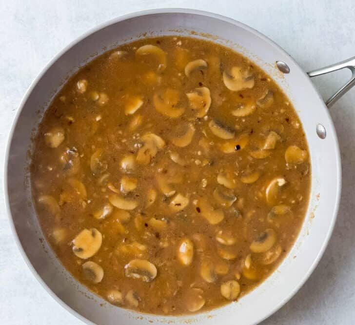 Let the gravy cook until it thickens, stirring occasionally to keep it smooth and lump-free.