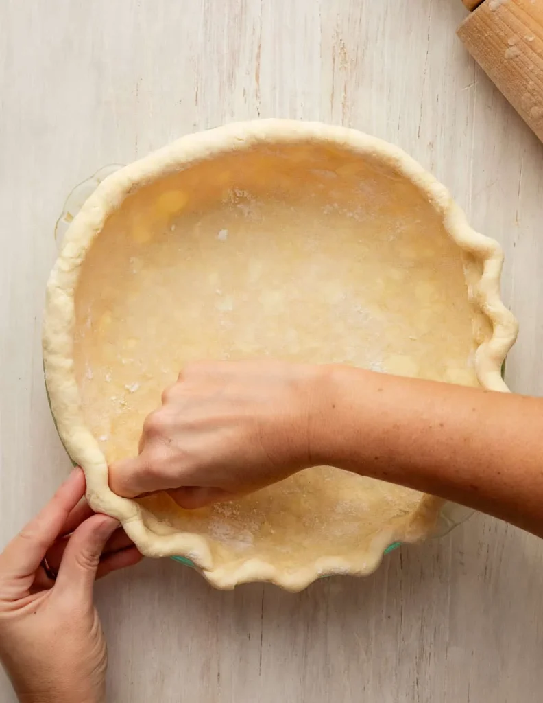 Shape the dough into a disc, wrap it, and refrigerate for at least two hours so it firms up and becomes easier to roll.